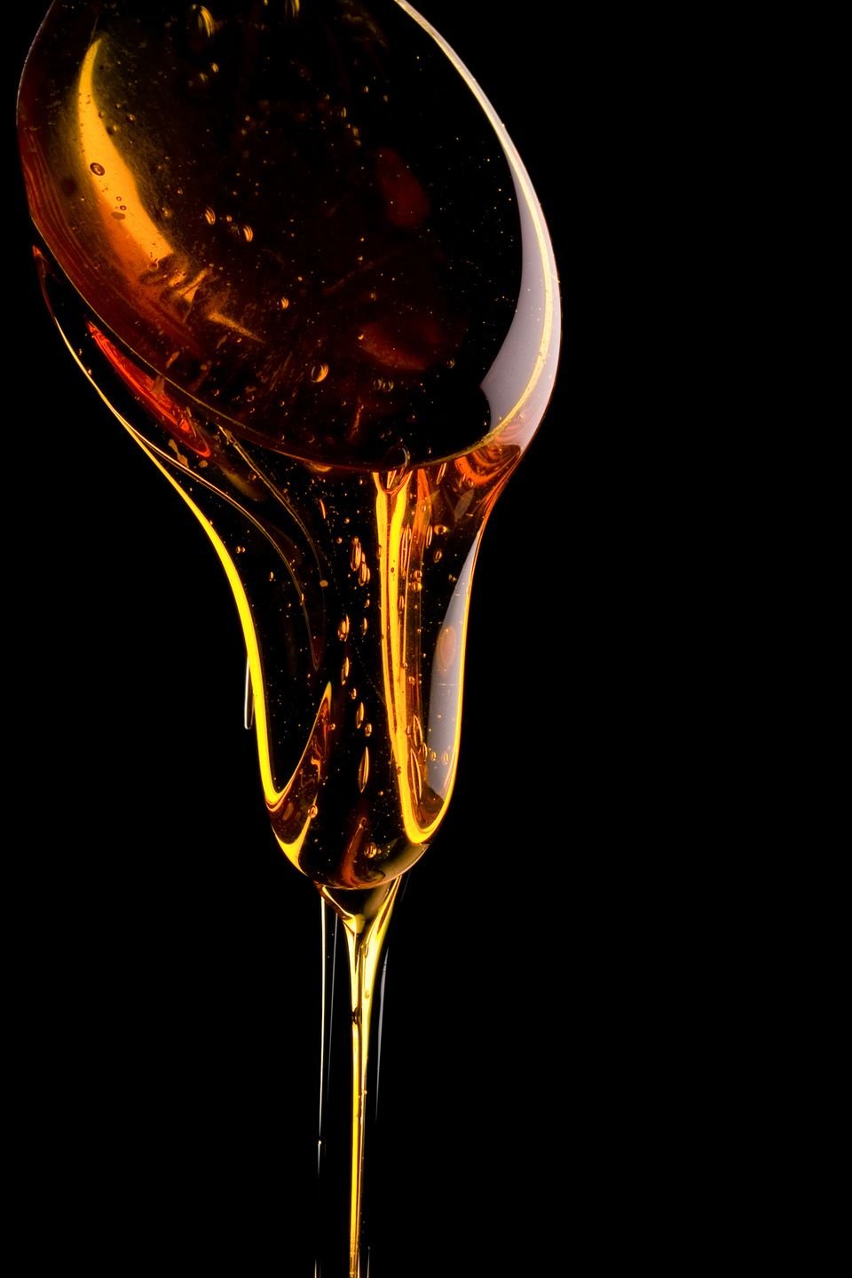 Rye bread and cardamom syrup pouring from a spoon